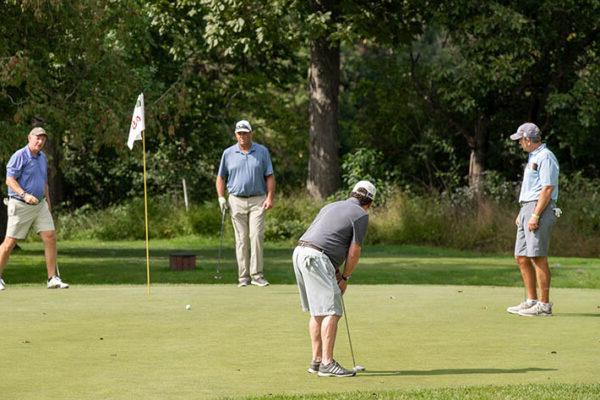 Golfers putting at LCCC Golf Classic